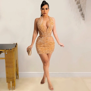 Detail of champagne gold sequin halter dress with daring waist cutouts for parties
