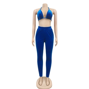 Détail d'un ensemble bleu en velours avec crop top licou et pantalon taille haute élastique