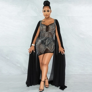 Detail of black mesh bodycon dress featuring sparkling rhinestones and long chiffon cape
