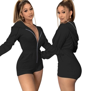 Detail of a slim-fit black hooded romper with front zipper closure and waist-defining design