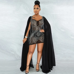 Detailed close-up of luxury black mesh party dress with silver rhinestones and long cape sleeves