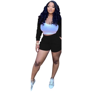 Three-piece women's lounge set featuring black zip jacket, white crop top and shorts