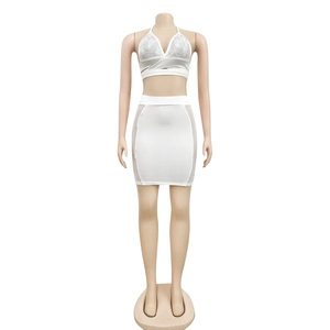 Detail view of white two-piece set featuring sequin halter top and mesh panel mini skirt