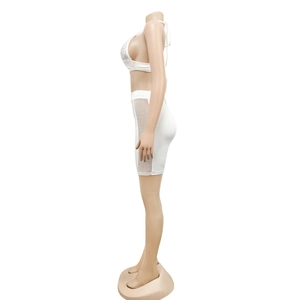 Detail view of the side mesh stitching and sequin craft on the white two-piece clubwear outfit