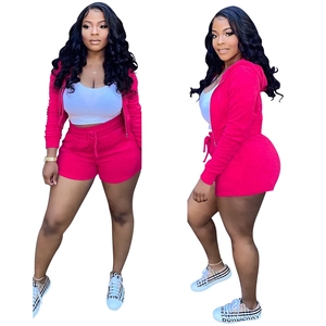 Detail of hot pink velvet crop hoodie and drawstring shorts set with zipper closure