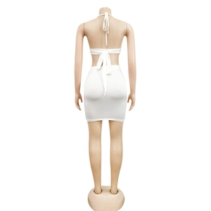 Detailed back view of white two-piece set featuring halter top ties and bodycon mini skirt