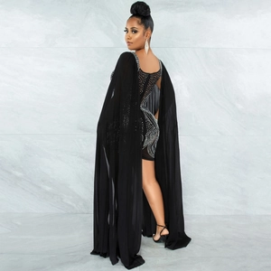 Macro detail of luxury black mesh evening dress with intricate silver rhinestone patterns