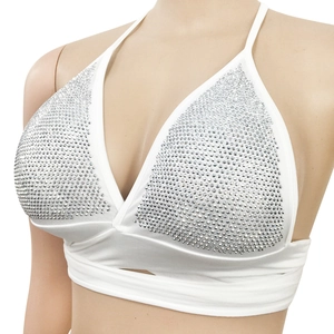 Detailed close-up of white halter neck crop top with silver rhinestone embellishments