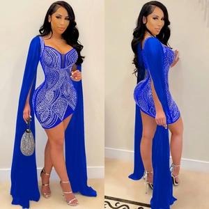 Detail of blue rhinestone mesh party dress featuring dramatic floor-length cape sleeves