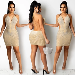 Close-up of sparkling silver rhinestones on champagne mesh mini dress with cutout details