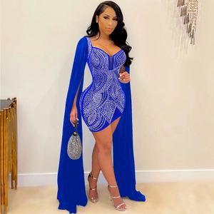 Detail of royal blue party dress featuring rhinestone patterns and long cape sleeves
