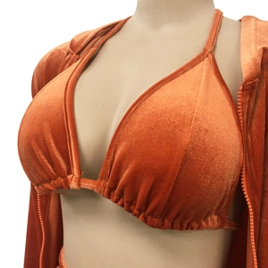 Détail du haut de bikini en velours orange et du sweat à capuche zippé assorti femme