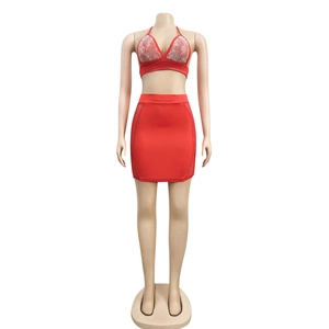 Detail of red two-piece set featuring shimmering rhinestones and mesh side panels