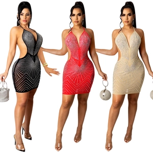 Close-up of sexy halter neck mini dresses with rhinestones and cutout waist detail