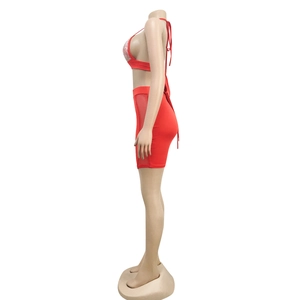 Detail of red two-piece set featuring sparkling rhinestones and side mesh patchwork