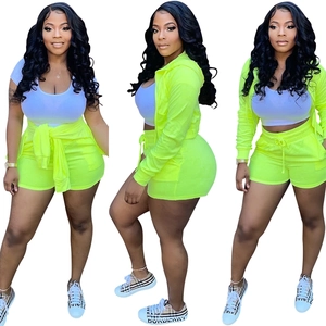 Three-piece neon yellow sport set including hoodie, drawstring shorts and white crop top