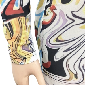 Détail du tissu en maille transparente avec motifs graffiti abstraits colorés et coutures