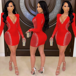 Detail of red deep V-neck mini dress featuring silver rhinestones and sheer mesh side panels