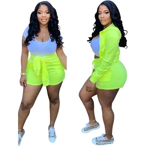 Three-piece lounge set with lime green hoodie, matching shorts and white crop top vest