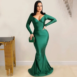 Close-up of deep green satin dress showing elegant V-neck and luxurious silk-like fabric texture