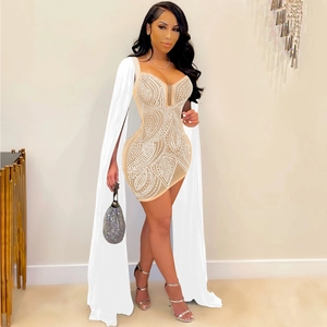 Detail of the intricate white geometric beadwork and sequins on a sexy beige bodycon dress