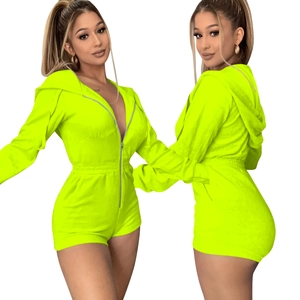 Detail of neon green velvet romper with front zipper, hoodie and elastic waist feature