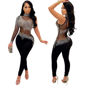 Detail of sheer mesh stitching and sparkling rhinestones on a black one-shoulder jumpsuit