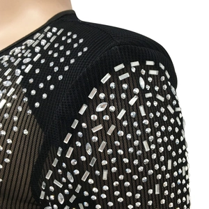 Détail de strass étincelants sur un tissu en maille noire pour robe de femme