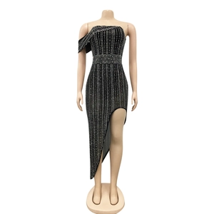 Detail of evening dress with sparkling rhinestones and elegant asymmetrical split hem