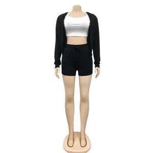 Detail of three-piece women set with black zip hoodie, white crop top and shorts