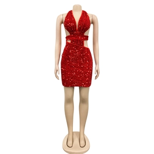 Detail of red sequin halter mini dress featuring waist cut-outs and criss-cross bandage style