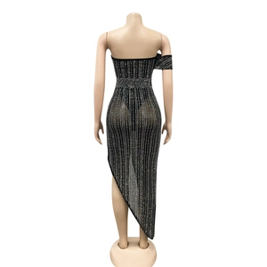 Back view of bodycon black strapless dress with vertical rhinestones and asymmetric hem