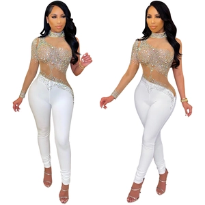 Detail of sheer mesh bodysuit with shimmering rhinestones and asymmetric shoulder cut