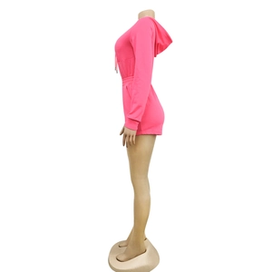 Side view of bright neon pink long sleeve hooded romper with elastic waist and pockets