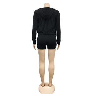 Detail view of the high-waisted shorts and back of the hooded jacket in black knit