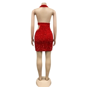 Detail of red sequined halter dress featuring an open back and side waist cut-outs