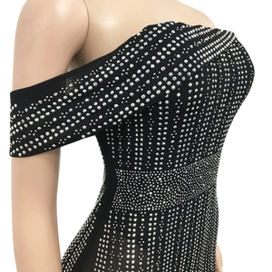 Detail of black off-shoulder evening dress featuring shimmering silver rhinestones and studs