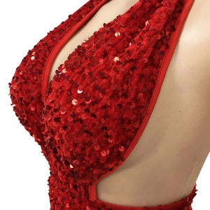 Detail of red sequined halter dress with velvet fabric and hollowed-out back design