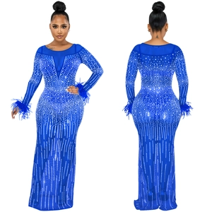 Dettaglio dell'abito in mesh blu reale con strass scintillanti e polsini in piuma