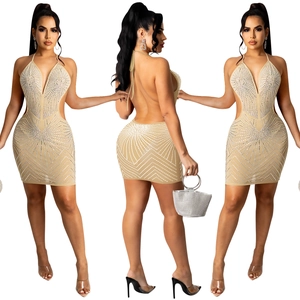 Detail of backless beige rhinestone dress with waist cut-outs and shimmering crystal patterns