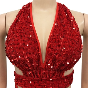 Detail of red sequin halter dress featuring a deep V-neckline and side cut-outs