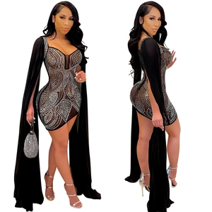 Detail of black mesh mini dress with silver rhinestones and long cape sleeves