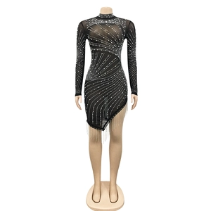 Macro view of mesh dress detailing shimmering rhinestones and silver chain tassels
