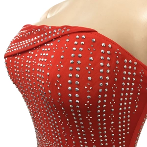 Detail of red mesh evening dress featuring densely packed shimmering silver rhinestones