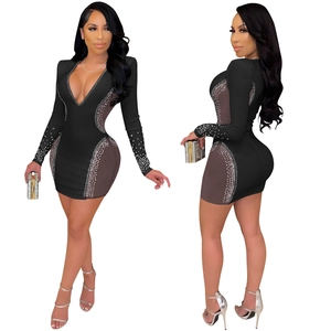 Detail of sexy deep V-neck dress with sheer mesh inserts and silver rhinestone embellishments