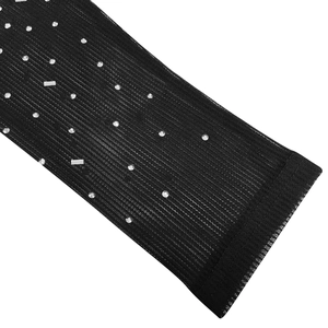 Gros plan sur tissu en maille noire avec strass brillants et texture verticale
