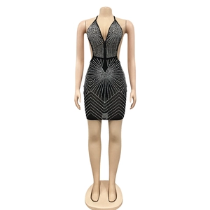 Detailed view of black rhinestone mini dress featuring a deep V-neck and mesh see-through fabric