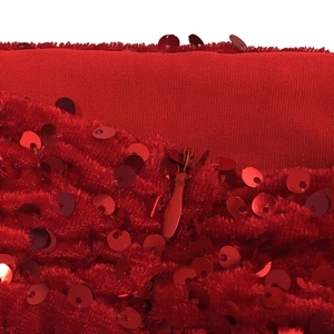 Close-up of red sequin embellishments and invisible zipper detail on haltered mini dress