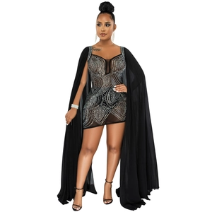 Detail of black mesh mini dress featuring rhinestones and long flowing tulle sleeves