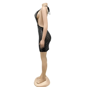 Detail of black halter backless mini dress with sparkling silver rhinestone pattern